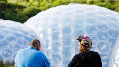 Two people looking out onto the Biome's in the background